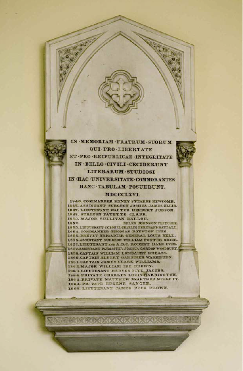 Photograph of a white marbled plaque memorial with ornate columns